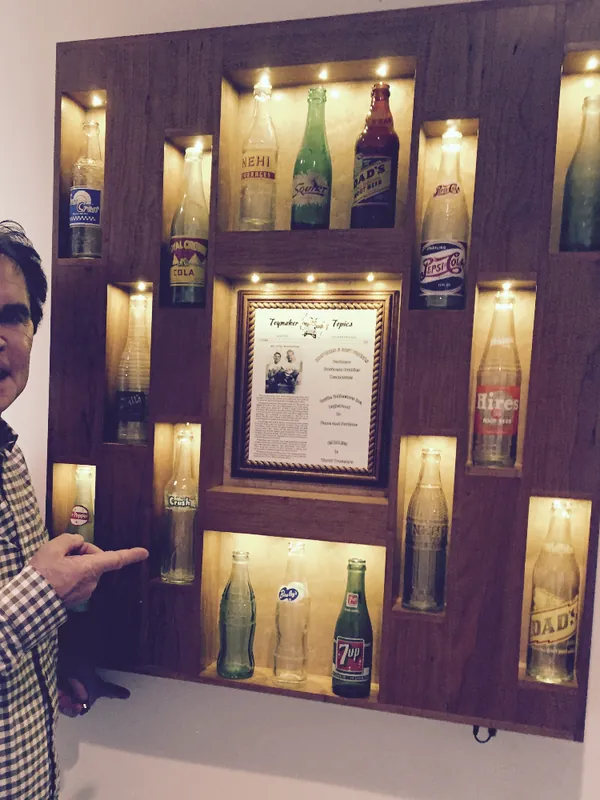 Joe holding the pop bottle display we built for his brother