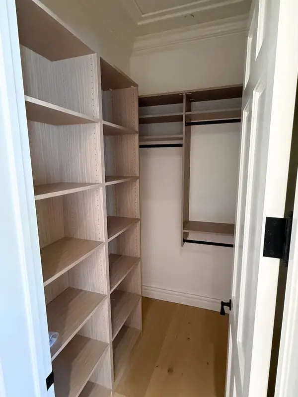 Closet with a tall adjustable shelving tower and double hanging rods, Thousand Oaks
