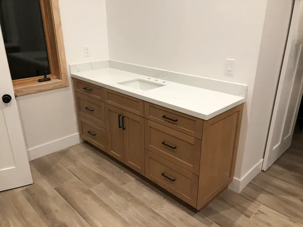 Light oak shaker vanity with drawers, black pulls and a white quartz top, Santa Rosa Valley