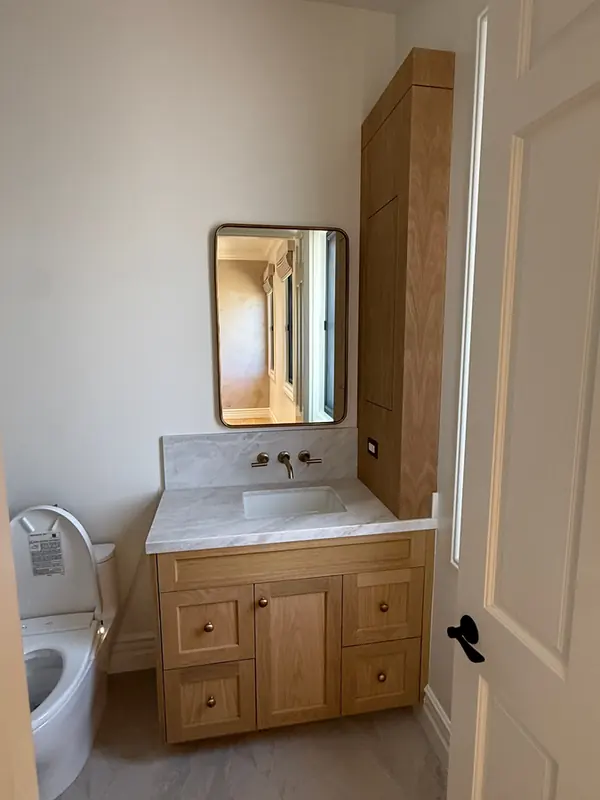 Oak shaker vanity with a tall linen cabinet and a stone top, Thousand Oaks
